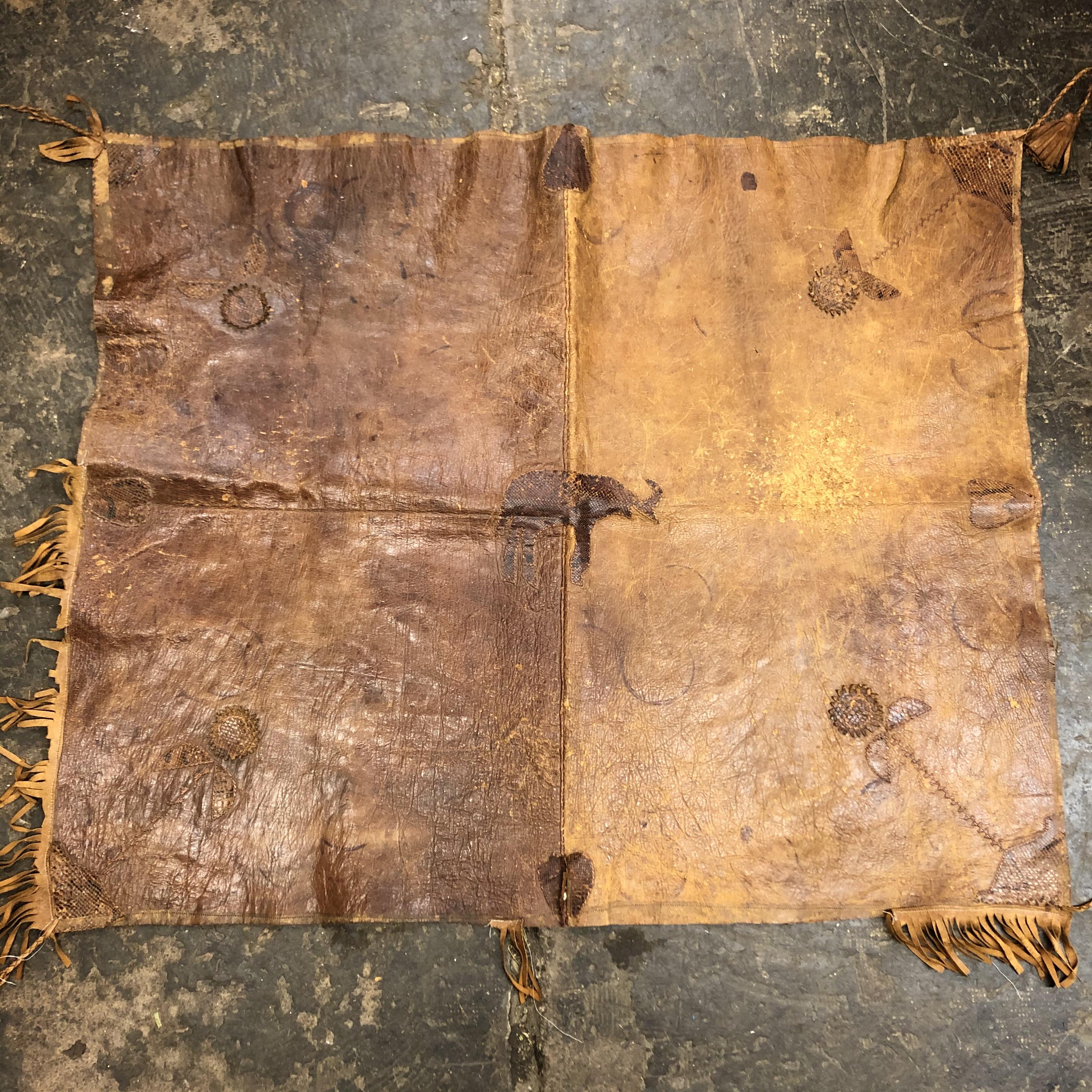 REME CARVED WOODEN PANEL, AN ANIMAL HIDE FRINGED SADDLE MAT, - Image 3 of 4