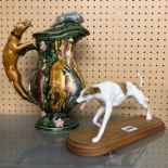 HUNTING SCENE CERAMIC PITCHER JUG WITH DOG HANDLE A/F 28CM H AND A CERAMIC GREYHOUND FIGURE MOUNTED