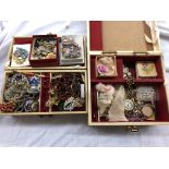 TWO CASES OF COSTUME JEWELLERY INCLUDING BROOCHES, ENAMEL BADGES, NECKLACES,