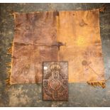 REME CARVED WOODEN PANEL, AN ANIMAL HIDE FRINGED SADDLE MAT,