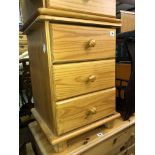 PAIR OF PINE THREE DRAWER BEDSIDE CHESTS AND AN OVAL MAGAZINE TABLE