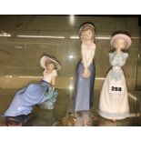 THREE NAO SPANISH PORCELAIN GIRL WITH BONNET FIGURES