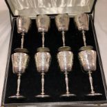 CASED SET OF EIGHT SILVER GILT ENGRAVED GOBLETS,