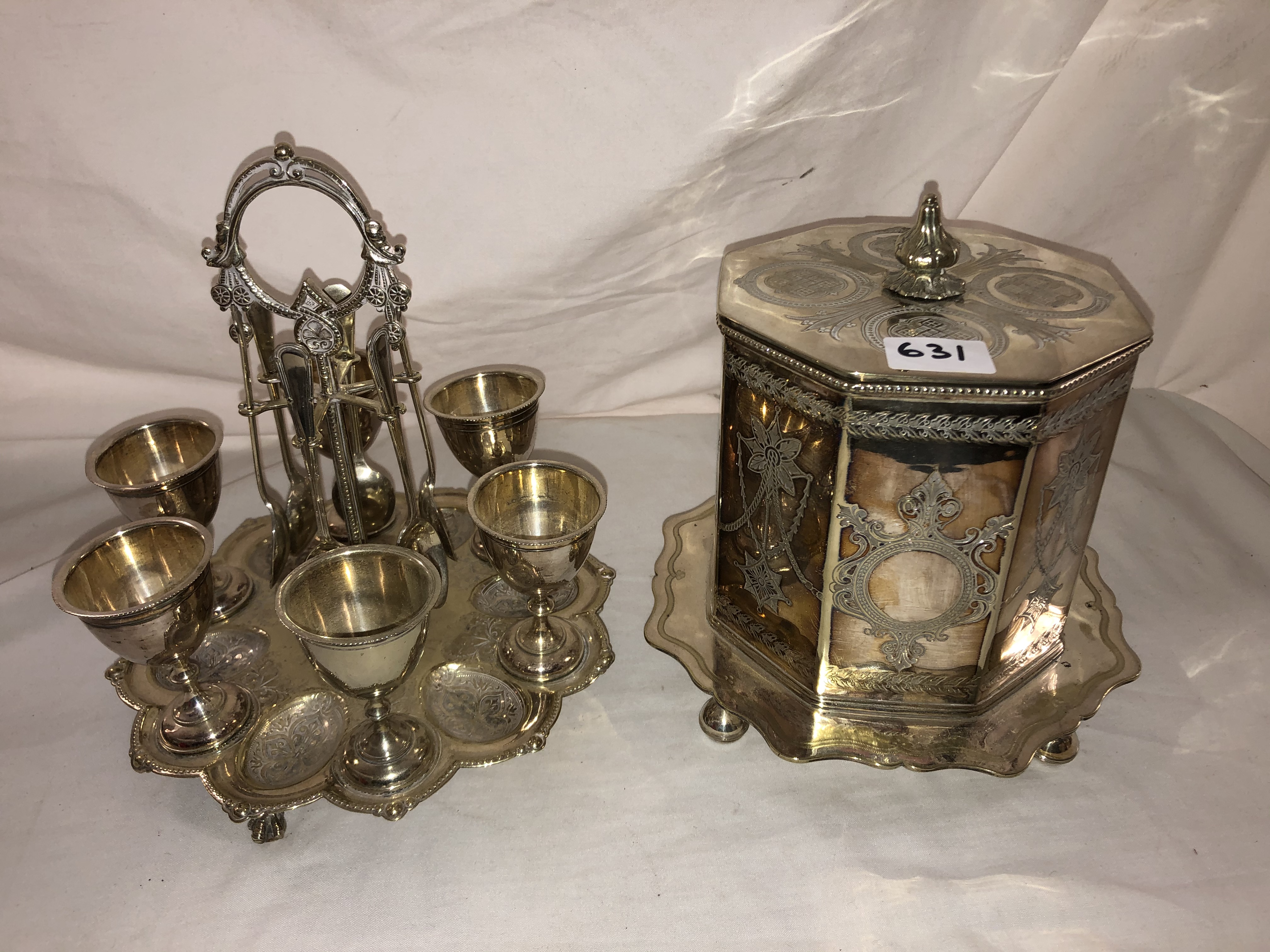 EPBM OCTAGONAL ENGRAVED BISCUIT BARREL AND PLATED SIX PLACE EGG CRUET WITH SPOONS