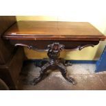 EARLY VICTORIAN ROSEWOOD FOLDOVER TOP BAIZE LINED GAMES TABLE ON BULBOUS COLUMN WITH CARVED
