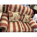 VICTORIAN STYLE TERRACOTTA AND OATMEAL STRIPED FABRIC TWO SEATER SOFA AND ARMCHAIR ON BRASS CASTORS