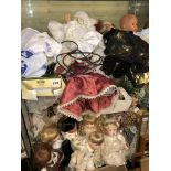 TWO SHELVES OF MAINLY PORCELAIN HEADED DRESS DOLLS