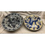 18TH CENTURY TIN GLAZED EARTHENWARE DELFT CHARGER AND A 20TH CENTURY SPANISH WALL PLATE