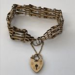 9CT GOLD FIVE GATE BRACELET WITH HEART PADLOCK AND SAFETY CHAIN 10.