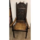 OAK HIGH BACKED ELBOW CHAIR WITH CARVED PANEL AND FRIEZE (DIMENSIONS-W.55CM,H.120CM,D.