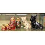 TWO PAINTED BABUSHKA DOLLS AND TWO CAST IRON SEATED TERRIER FIGURES