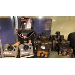 SHELF OF POLAROID LAND CAMERAS INCLUDING THE BUTTON, COLOUR SWINGER, COLOUR PACK AND SUPER SWINGER,