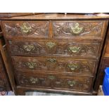 GEORGIAN OAK TWO OVER THREE DRAWER CHEST ON BRACKET FEET WITH LATER CARVED DRAWER FRONTS