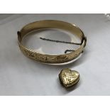 ROLLED GOLD HEART SHAPED LOCKET AND A 9CT METAL CORE ENGRAVED BANGLE