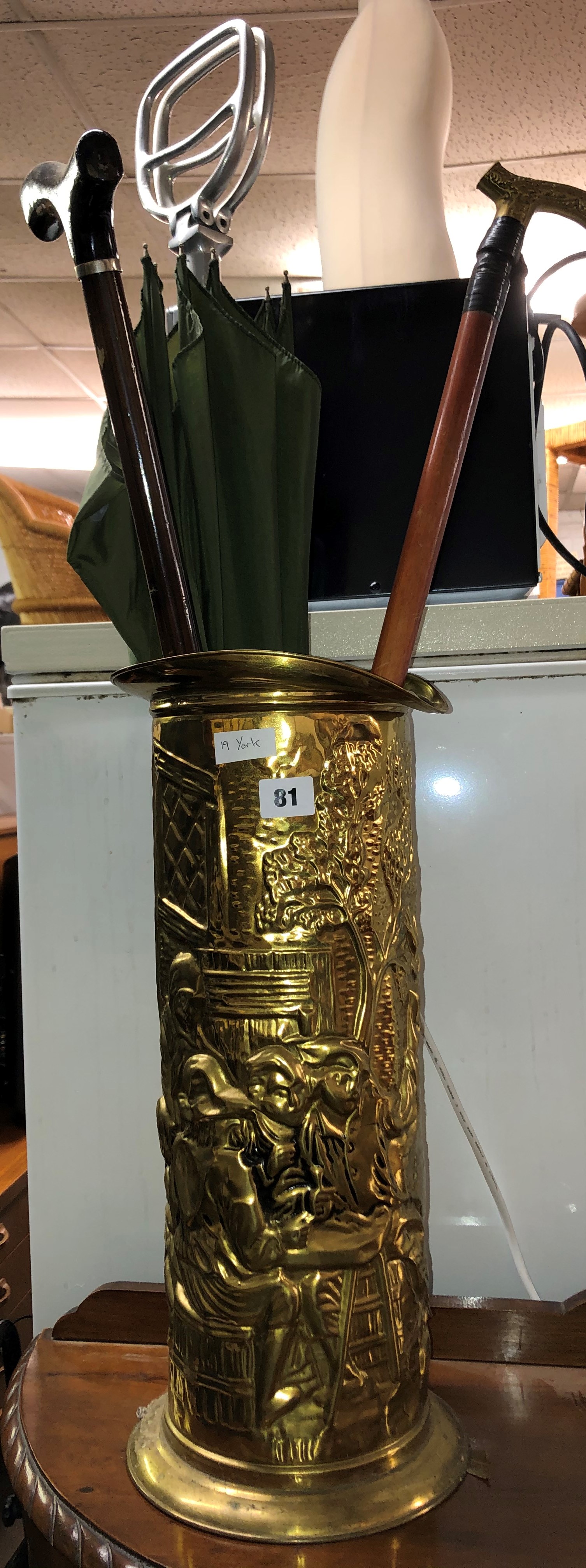 BRASS EMBOSSED CYLINDRICAL CANE STAND WITH CANES AND UMBRELLA,