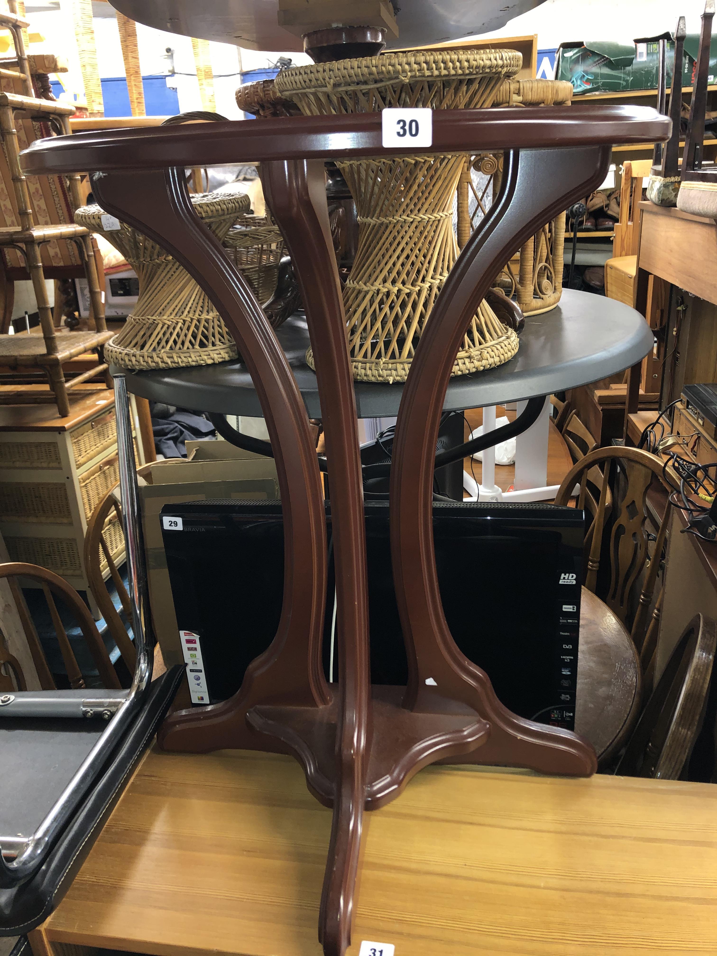 MAHOGANY DEMI LUNE SIDE TABLE ON CONCAVE TRIFORM BASE AND A ROLLED CREAM RUG