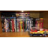 SHELF OF ASSORTED DVDS