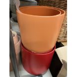 TWO ORANGE AND TWO RED PLANTERS/POTS