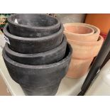 SET OF THREE TERRACOTA GRADUATED PLANT POTS AND FOUR CHARCOAL TERRACOTA PLANT POTS