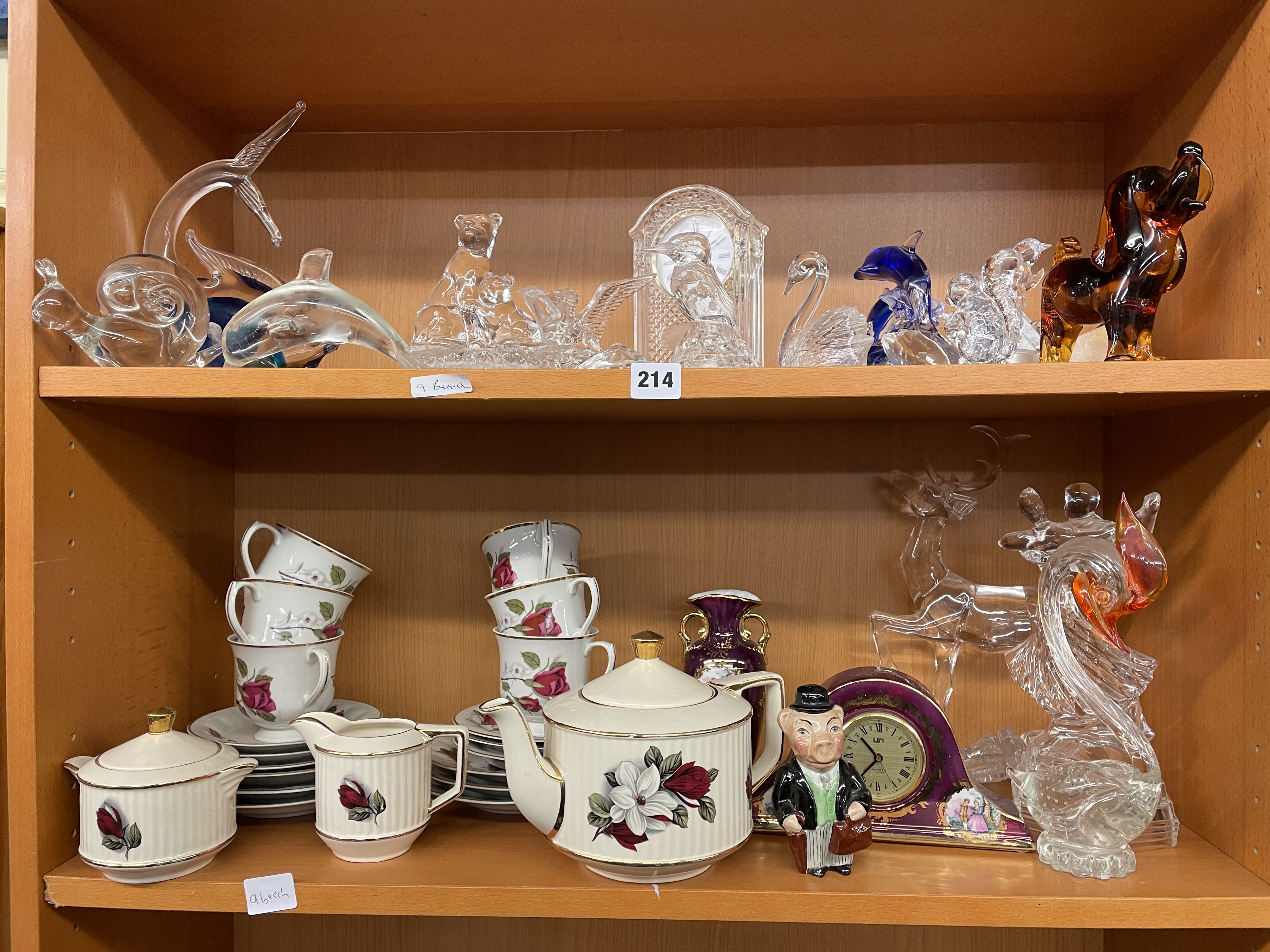 TWO SHELVES OF ASSORTED GLASS ANIMAL FIGURES, PORCELAIN CLOCK, TEA SET, ETC.