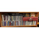 SHELF OF VARIOUS CDS AND TAPE CASSETTES