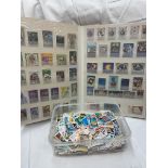 WORLD STAMP ALBUM AND PLASTIC BOX OF ASSORTED WORLD STAMPS