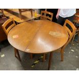 MATCHING TEAK CIRCULAR DINING TABLE AND FOUR UPHOLSTERED CHAIRS