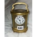 GILT METAL OVAL CARRIAGE CLOCK WITH KEY