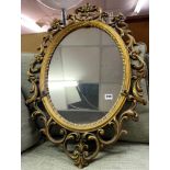 GILT OVAL ROPE EDGED MIRROR WITH ACANTHUS SCROLL DETAIL