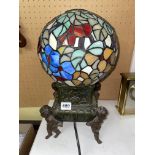 FOUR CHERUB BRONZE PATINATED TABLE LAMP WITH A STAINED GLASS GLOBULAR SHADE