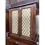 REGENCY MAHOGANY PIER CABINET WITH PAIR OF CUPBOARD DOORS HAVING BRASS GRILLES BACKED IN PLEATED
