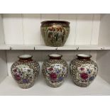 THREE ORIENTAL STYLE OVOID VASES DECORATED WITH FLOWERS (TWO WITH HARDWOOD STANDS) AND A SMALL