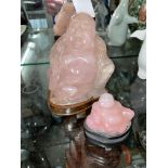 PINK QUARTZ CARVED FIGURE OF A BUDDHA ON PLINTH AND ONE SMALLER 14CM AND 7CM H