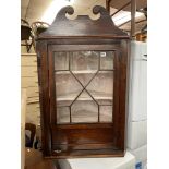 LATE GEORGIAN OAK AND MAHAOGNY ASTRAGAL GLAZED HANGING CORNER CABINET WITH SWAN NECK PEDIMENT