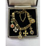 BOXED UNMARKED YELLOW CHAIN/BRACELET WITH MINIATURE ENAMEL MEDALLIC CHARMS