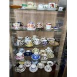 FIVE SHELVES OF VARIOUS BONE CHINA ON PORCELAIN COFFEE CANS AND SAUCERS AYNSLEY,STAFFORD ETC.