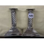 A PAIR OF SHEFFIELD SILVER DWARF WRYTHEN CANDLE STICKS ON STEPPED LOADED BASES