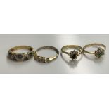 FOUR UNMARKED YELLOW METAL AND STONE SET RINGS