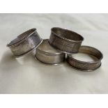 THREE SILVER NAPKIN RINGS AND ONE OTHER