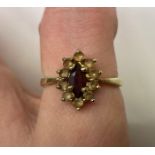 A 9CT GOLD MARQUIS GARNET AND CZ CLUSTER DRESS RING, SIZE O, 2.