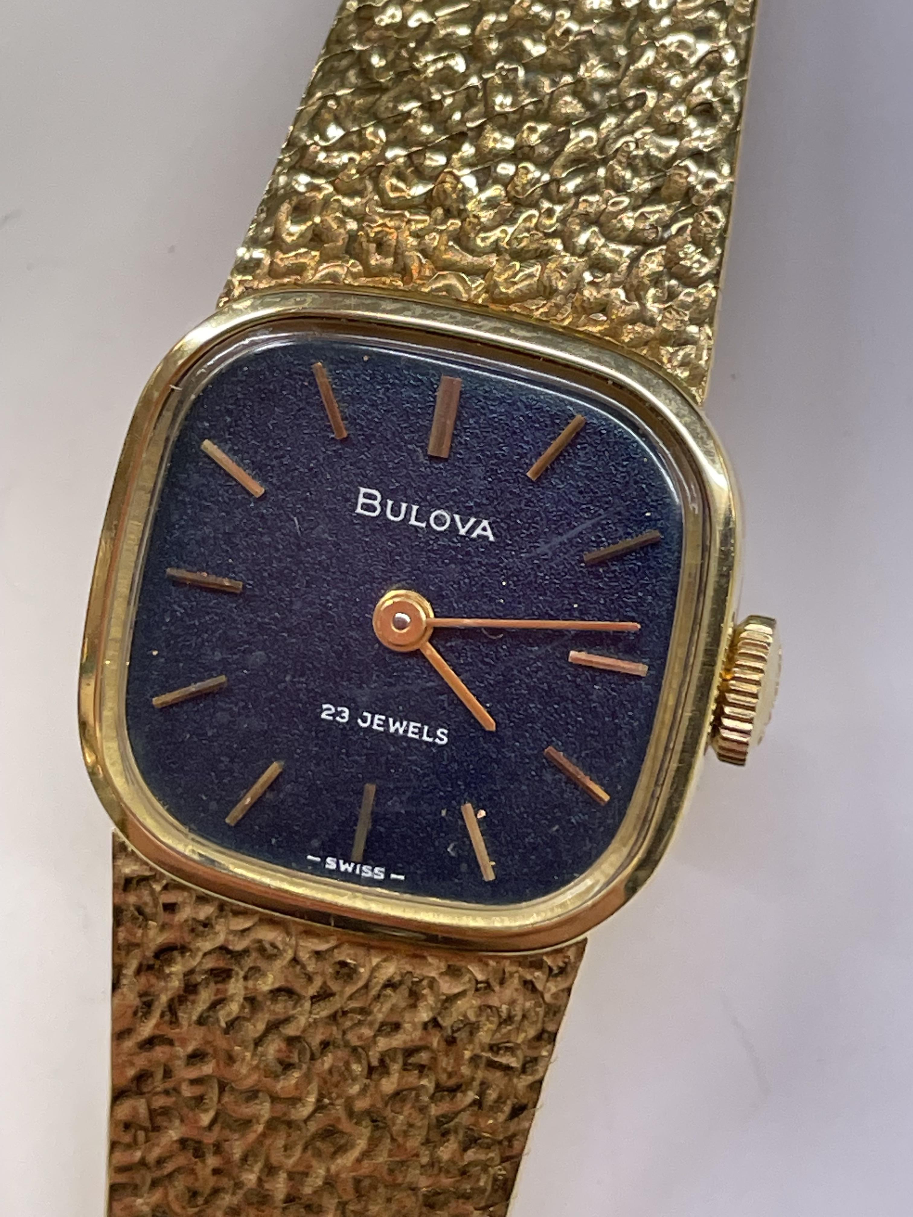 LADIES BULOVA BARK EFFECT GOLD CASED WRIST WATCH AND STRAP STAMPED 750, 35.