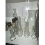 THREE WRYTHEN MOULDED GLASS OIL LAMPS AND A SELECTION OF GLASS LAMP CHIMNEYS