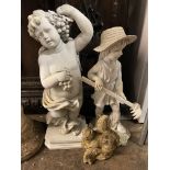 TWO STONE EFFECT GARDEN ORNAMENTS - A CHERUB AND A FIGURE WITH A RAKE