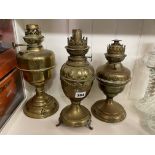 THREE LATE 19TH/EARLY 20TH CENTURY BRASS BALUSTER AND OVOID BODIED OIL LAMPS (WITHOUT SHADES OR