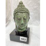 VERDI GRIS METALWORK HEAD OF A BUDDHA ON A SQUARE BASE 19CM