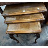 NEST OF THREE CARVED WALNUT TABLES