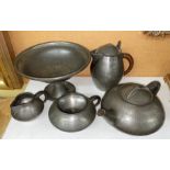 LIBERTY AND CO BEATEN PEWTER FOUR PIECE TEA SERVICE NUMBERED 0232 WICKER ON HANDLE A/F AND AN OLD