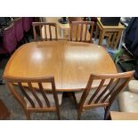 TEAK OVOID CROSSBANDED EXTENDING DINING TABLE AND FOUR CHAIRS