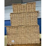 THREE GRADUATED RATTAN BASKETS WITH LIDS