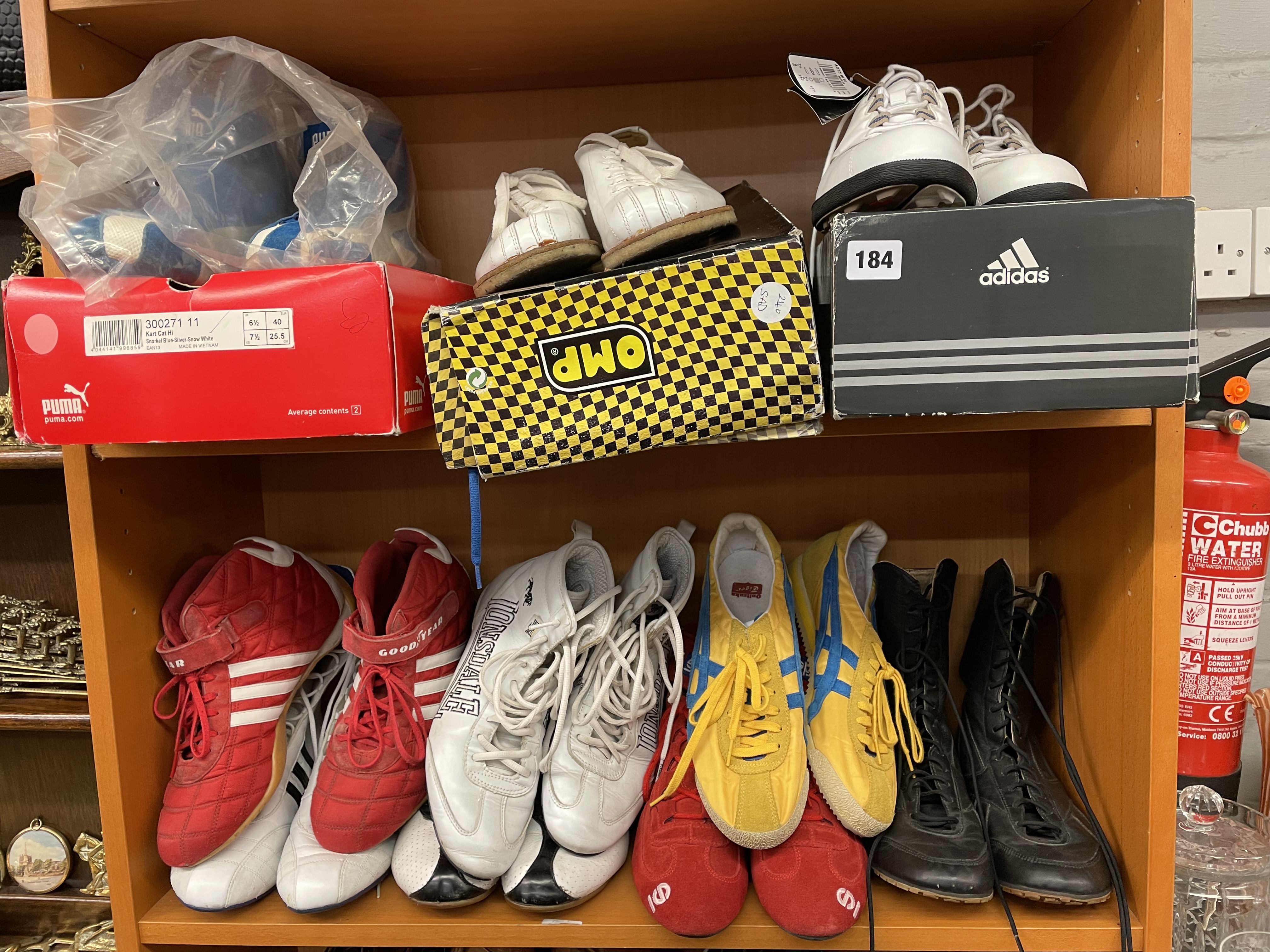 TWO SHELVES OF GOODYEAR, LONSDALE AND TIGER SPORTING SHOES AND A PAIR OF ADIDAS GOLF SHOES SIZE 6.